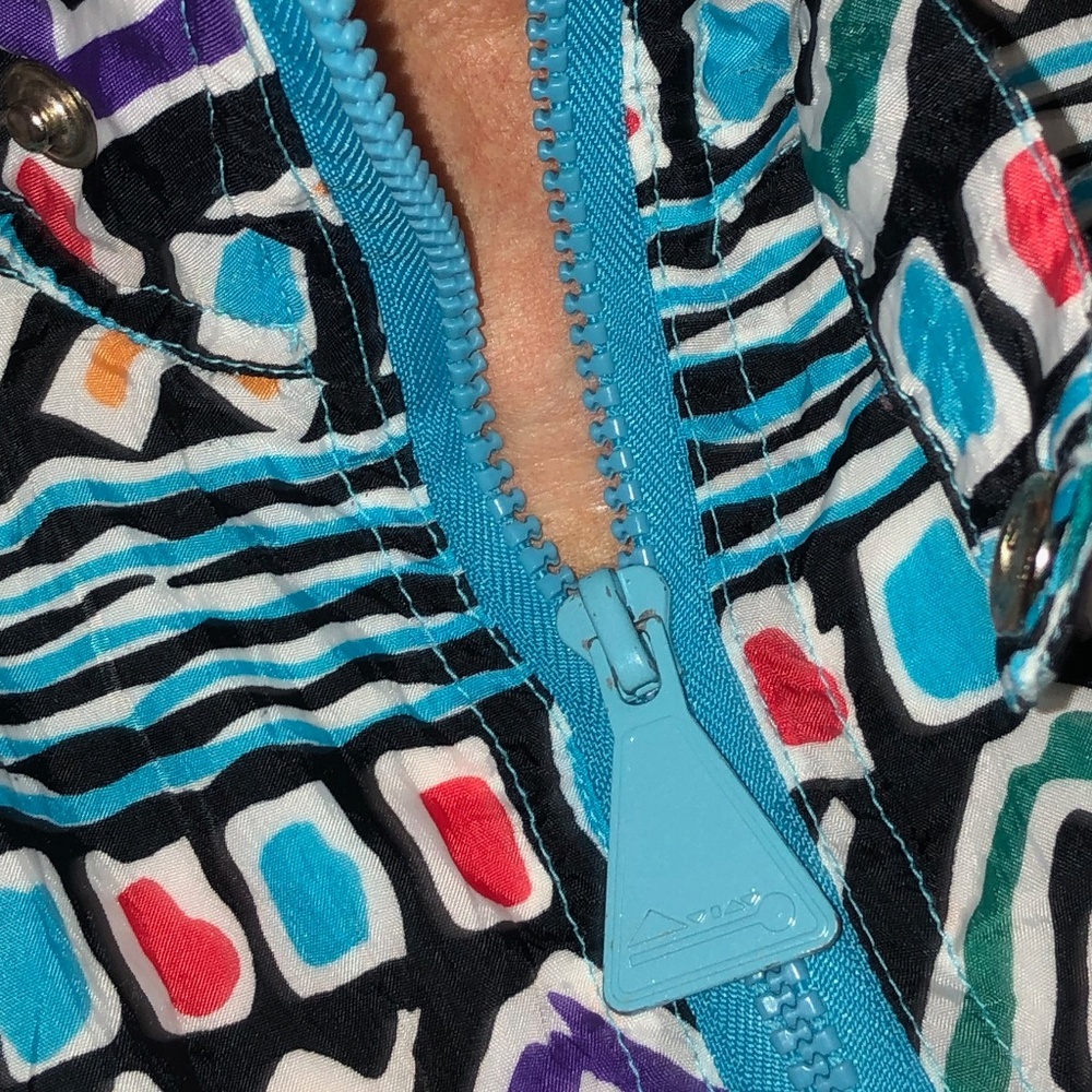Very fun lightweight jacket. Pocket, neck tab